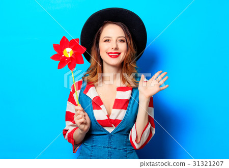 smiling woman with red pinwheel smiling woman with red pinwheel 31321207