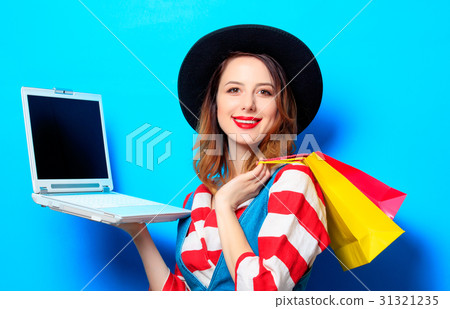 Woman with laptop and shopping bags 31321235
