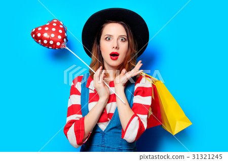 woman with shopping bags and heart shape toy woman with shopping bags and heart shape toy 31321245