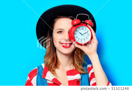 Woman with retro alarm clock 31321248