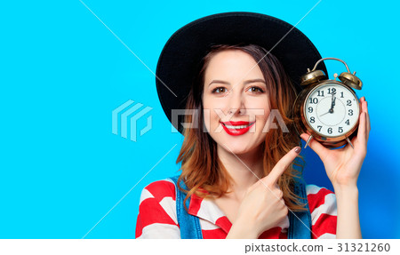 Woman with retro alarm clock 31321260