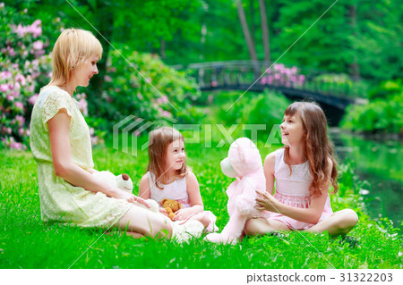 Young mother and two sisters in park Young mother and two sisters in park 31322203