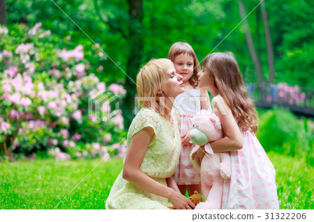 Young mother and two sisters in park Young mother and two sisters in park 31322206