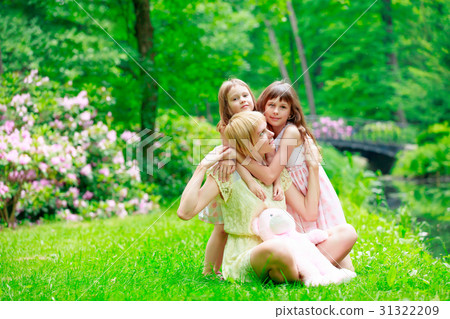 Young mother and two sisters in park Young mother and two sisters in park 31322209
