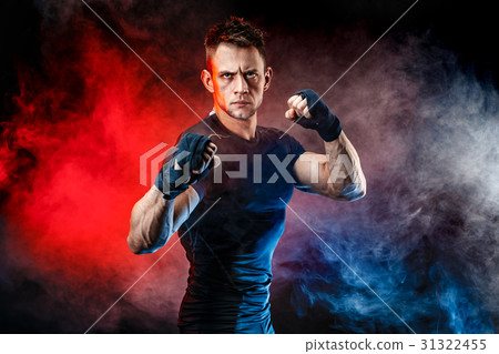Studio portrait of fighting muscular man in smoke 31322455