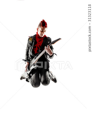Teen with red mohawk jumping while playing guitar 31323118