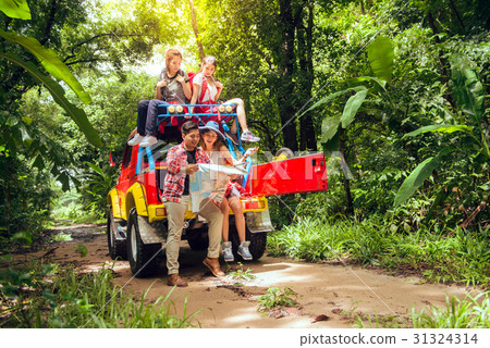 Happy asian young travellers with car off road Happy asian young travellers with car off road 31324314