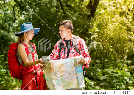 Hiking - hikers looking at map. 31324315