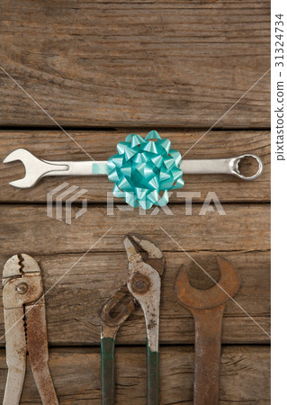 Wrench with ribbon by hand tools on table 31324734