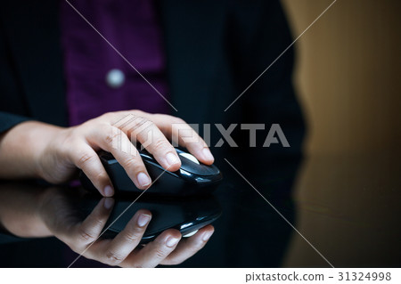 Close-up of businesswoman's hand on computer mouse 31324998