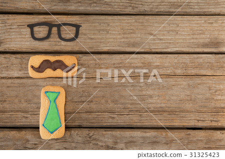 Cookies with mustache and necktie shape decoratio  31325423