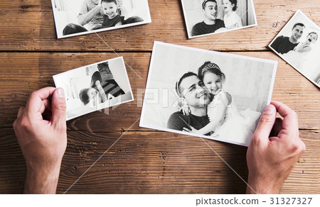 Pictures of father and daughter, wooden background 31327327