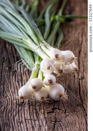 Onion. Fresh young onion on rustic oak table. Onion. Fresh young onion on rustic oak table. 31327644