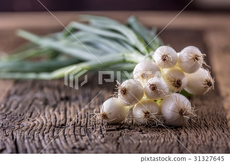Onion. Fresh young onion on rustic oak table. Onion. Fresh young onion on rustic oak table. 31327645