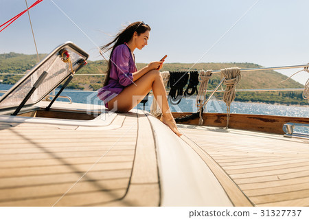woman travel with smartphone on yacht 31327737