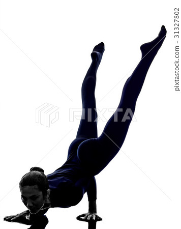 woman exercising Mayurasana peacock pose yoga 31327802