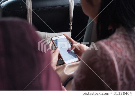 Close up girl using smart phone inside car. Close up girl using smart phone inside car. 31328464