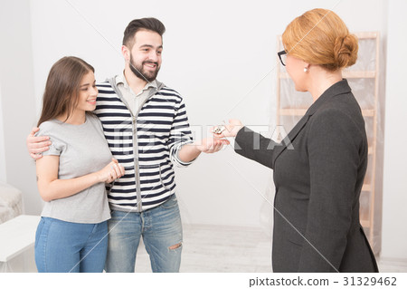 Receiving keys after purchasing a new home. 31329462