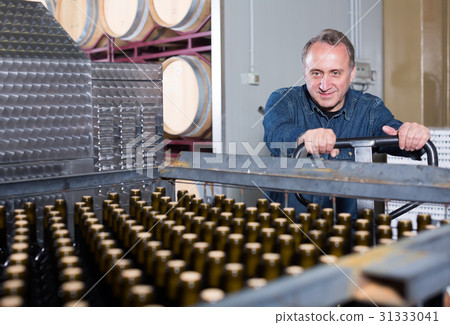 Glad wine maker unloads containers with bottles 31333041