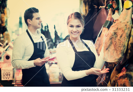 Portrait of sellers offering tasty jamon Portrait of sellers offering tasty jamon 31333231