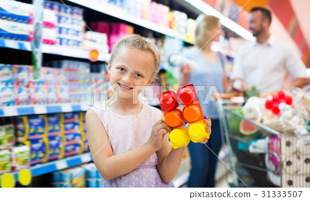 Portrait of girl holding package with yogurt Portrait of girl holding package with yogurt 31333507