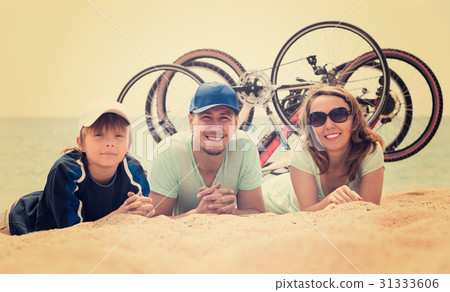 Family with bicycles on beach Family with bicycles on beach 31333606