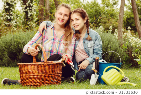young mother and dauther with gardening tools in outdoors 31333630