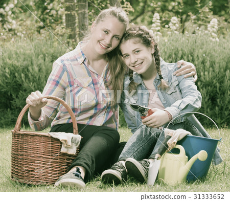 young mother and dauther with gardening tools in outdoors 31333652