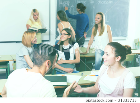 students chatting and smiling at the college students chatting and smiling at the college 31333713