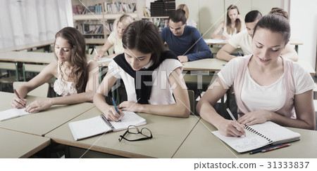 Students in classroom on exam Students in classroom on exam 31333837