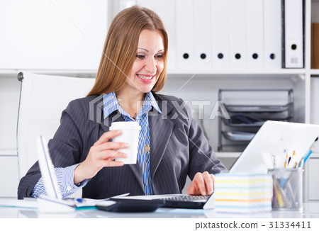 Business woman with coffee at workplace Business woman with coffee at workplace 31334411