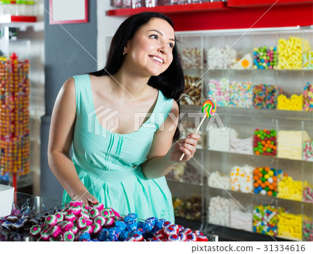 sexy cheerful girl posing in the store with lolly sexy cheerful girl posing in the store with lolly 31334616