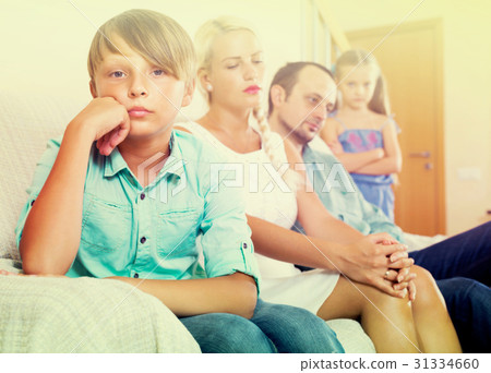 Parents and two kids in conflict at home. Parents and two kids in conflict at home. 31334660