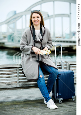 Female tourist standing at pier Female tourist standing at pier 31334663