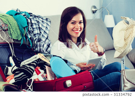 Woman booking online for holidays at home Woman booking online for holidays at home 31334792