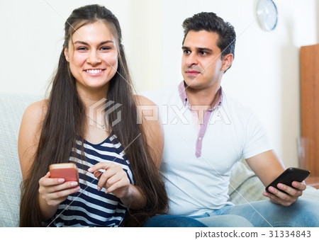 Couple networking with cell phones . 31334843