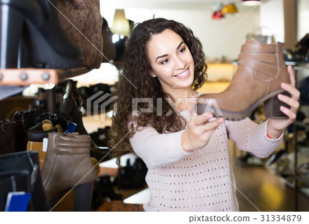 female buying winter female shoes in shoe store female buying winter female shoes in shoe store 31334879