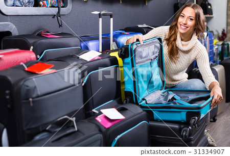 Female customer choosing travel suitcase 31334907