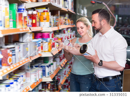 Positive couple choosing paint 31335031