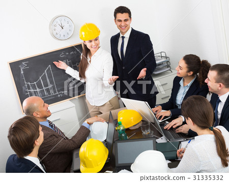 Group of engineers discussing project Group of engineers discussing project 31335332
