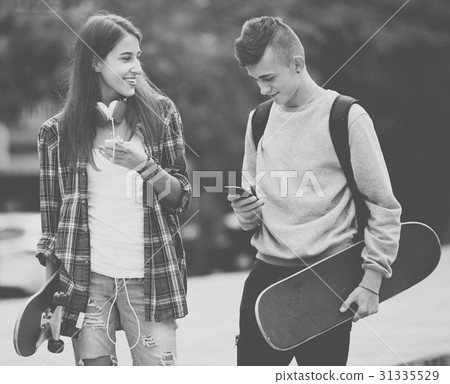 Teenagers with skateboards outdoors . 31335529