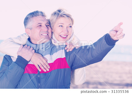 Adult husband points to something interesting 31335536