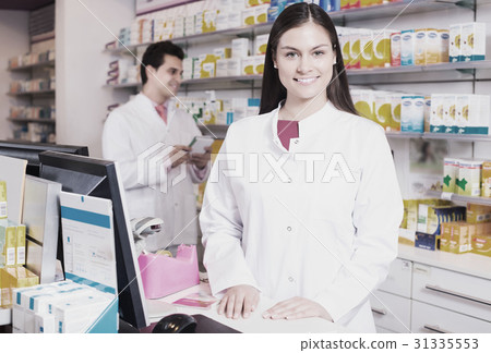 Pharmacist and assistant working 31335553