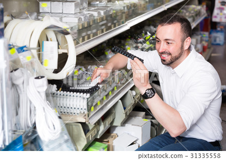 Portrait of young man selecting equipment 31335558