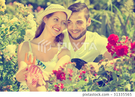 Happy family working in garden 31335565