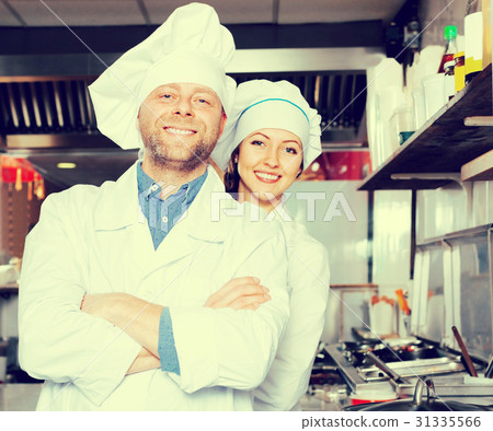cooks cooking at professional kitchen 31335566
