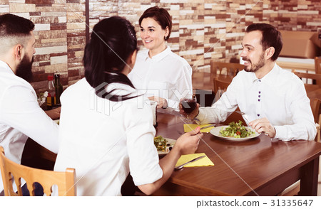 Smiling group of friends having dinner Smiling group of friends having dinner 31335647