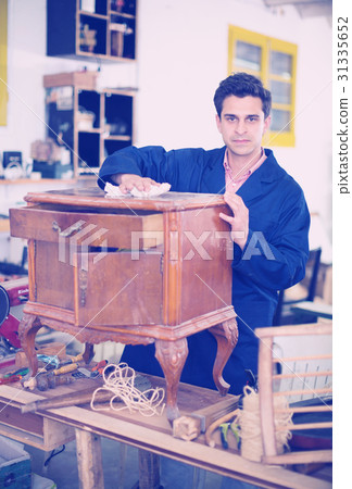 Restorer of furniture in workroom Restorer of furniture in workroom 31335652
