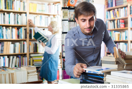 young man among bookshelves 31335865