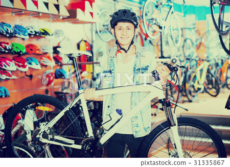 Young teenage boy looking for new sport bike Young teenage boy looking for new sport bike 31335867